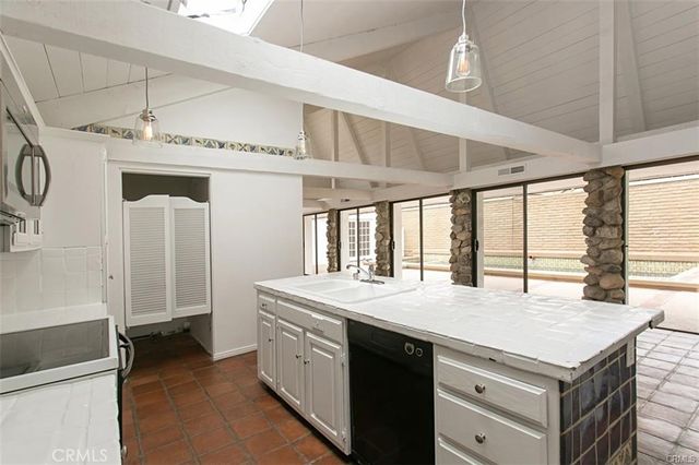 a kitchen with a stove and a sink