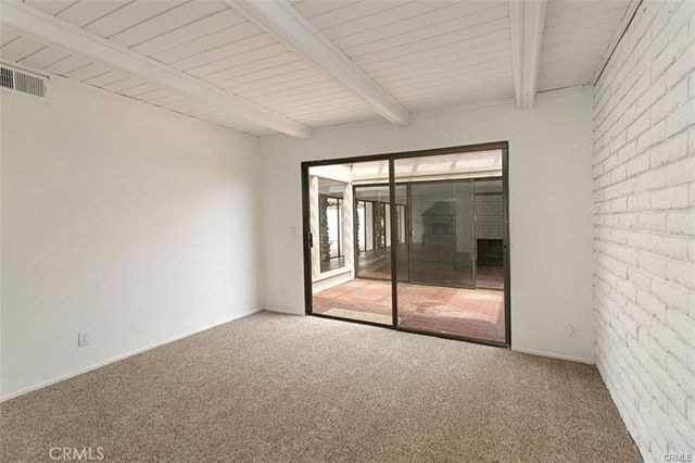 a view of an empty room with glass door