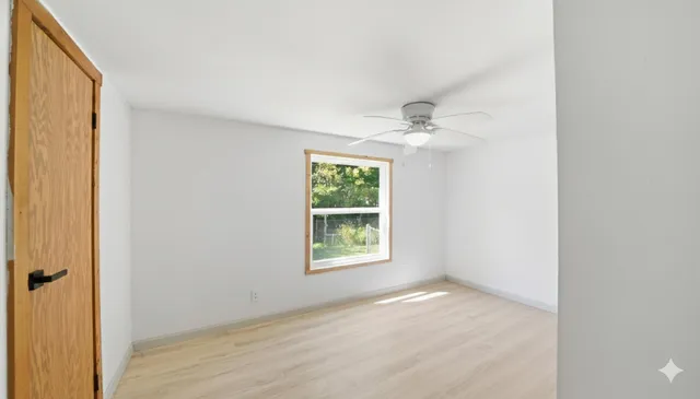wooden floor in an empty room with a window
