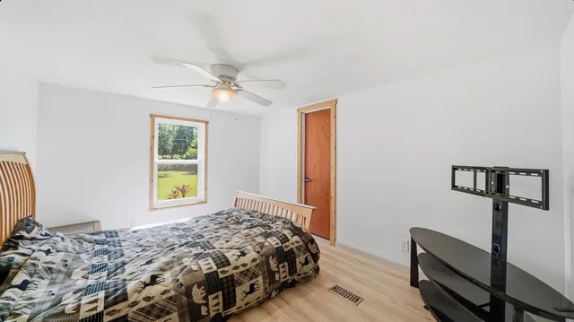 a bedroom with a bed and a window