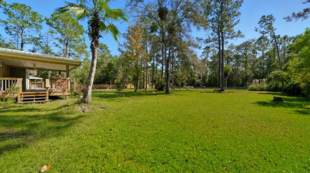 a view of outdoor space with deck and yard