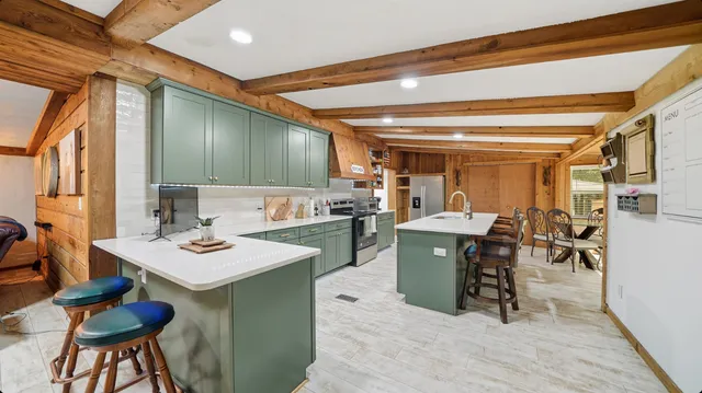 a kitchen with a table and chairs in it