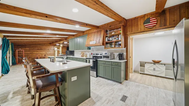 a kitchen with a stove a refrigerator and a kitchen island