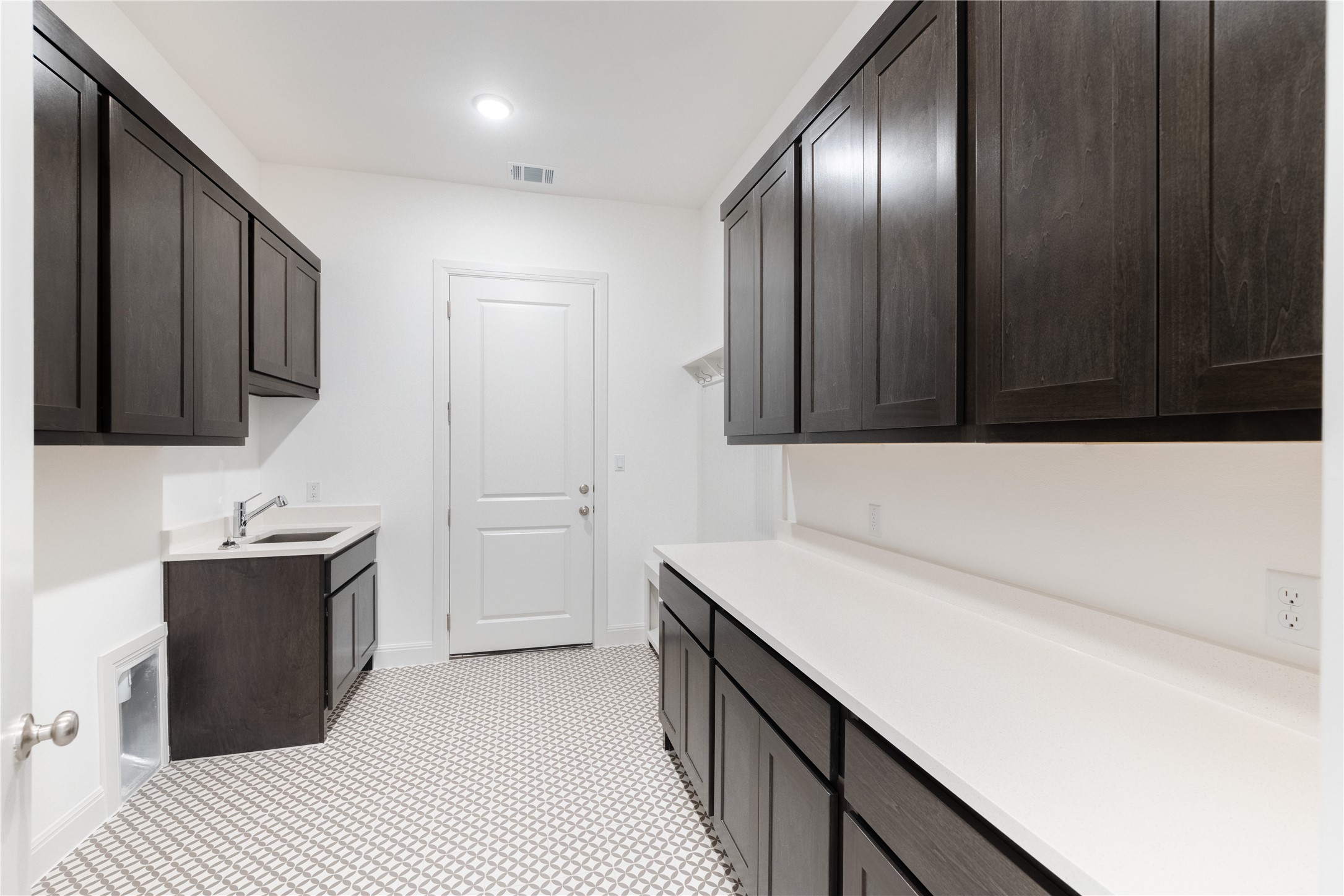 905 South Hemingway Loop Liberty Hill, TX 78642 - Photo 27 of 35 a kitchen with a sink and a refrigerator