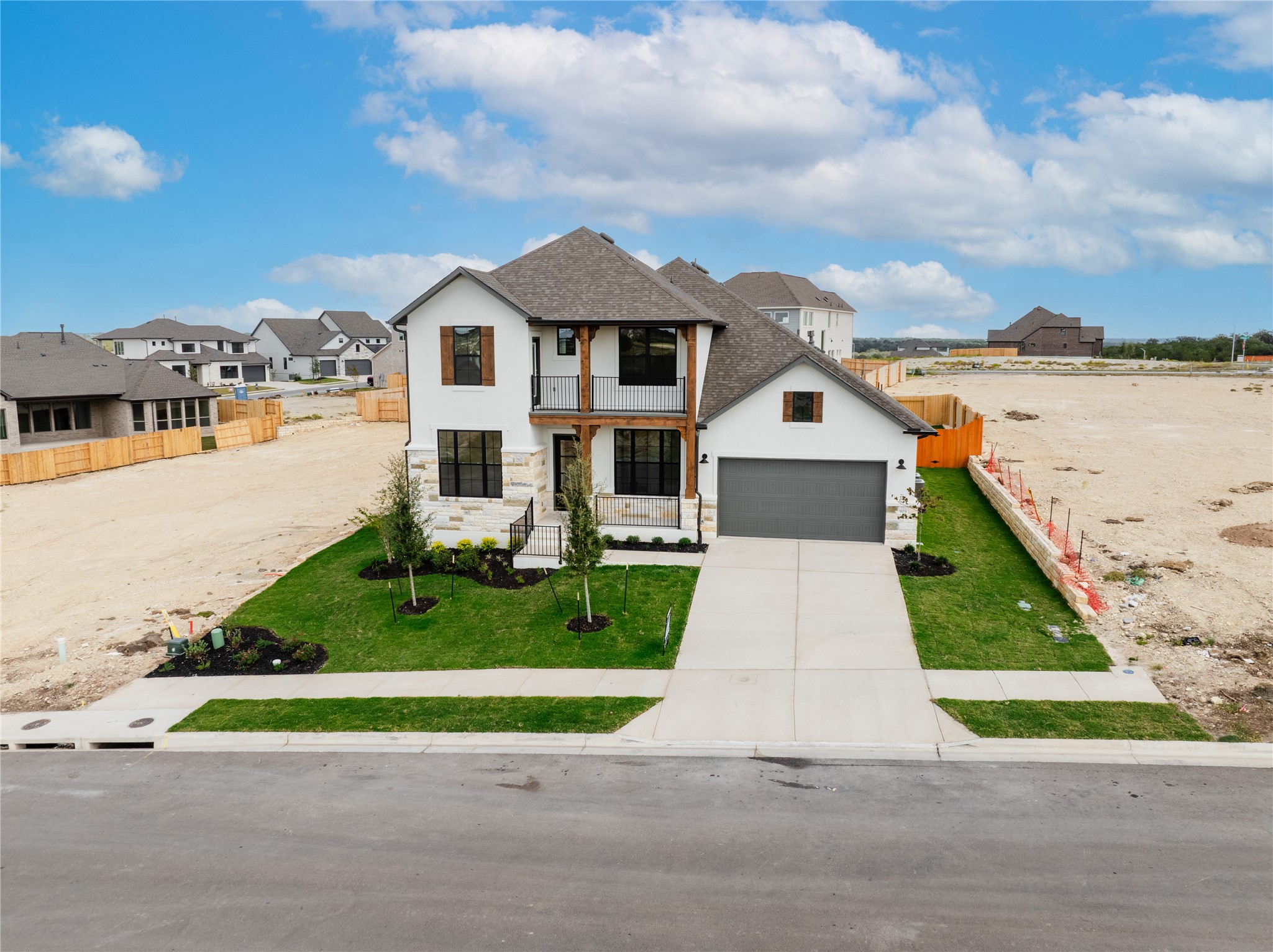 905 South Hemingway Loop Liberty Hill, TX 78642 - Photo 5 of 35 a front view of a house with a yard and garage