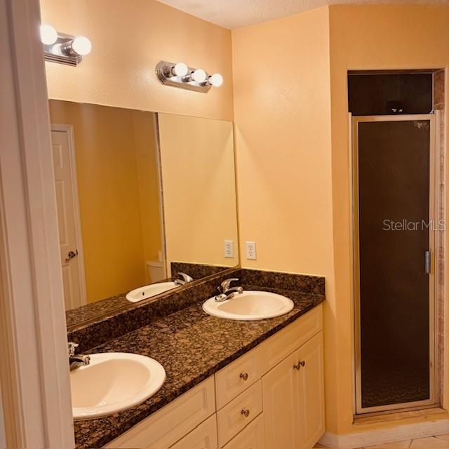 925 East Rembrandt Way, Unit 104 Inverness, FL 34453 - Photo 18 of 36 a bathroom with a sink and a mirror