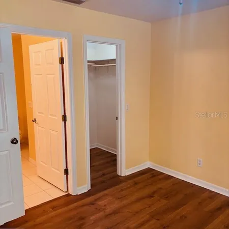 an empty room with wooden floor