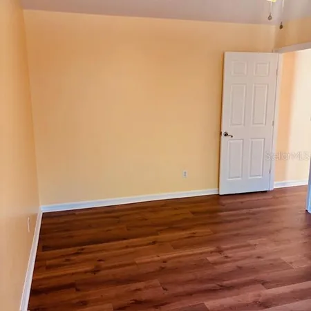 a view of room with window and wooden floor