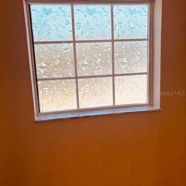 925 East Rembrandt Way, Unit 104 Inverness, FL 34453 - Photo 31 of 36 an empty room with a window
