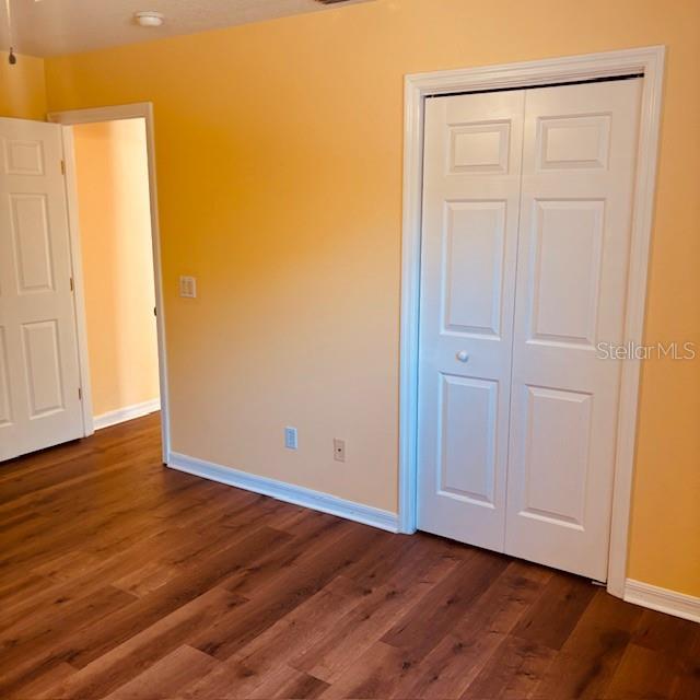 925 East Rembrandt Way, Unit 104 Inverness, FL 34453 - Photo 32 of 36 a view of an empty room with wooden floor