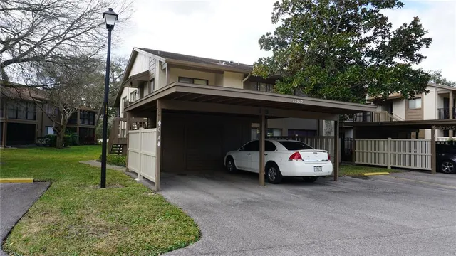 a car parked in front of a house with a yard