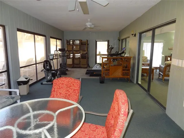 a living room with furniture and large windows