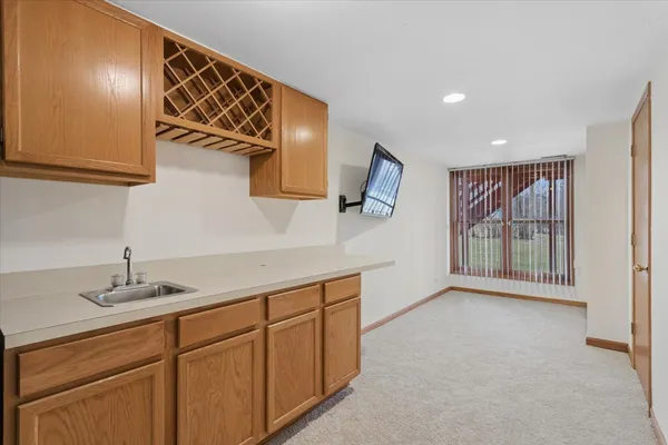 a hallway with a sink and mirror