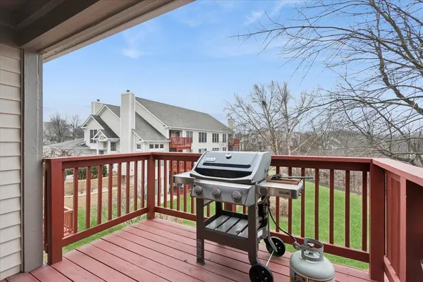 a view of a balcony with chairs and wooden fence