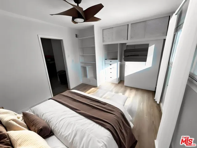 a bedroom with a bed and a mirror