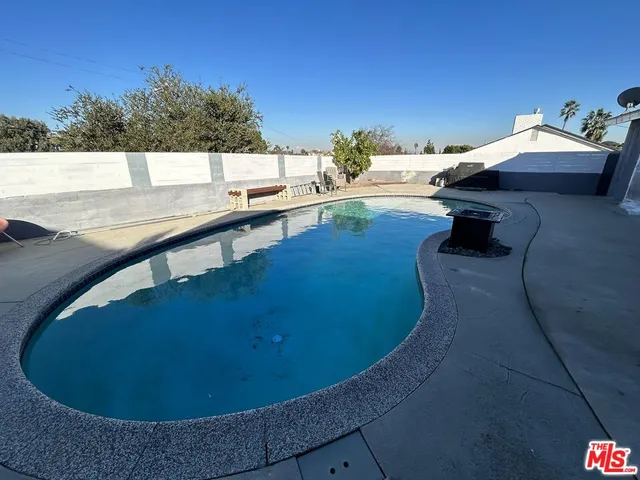 a view of a swimming pool with an outdoor seating