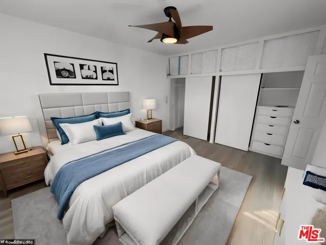 a bedroom with a bed and a large mirror