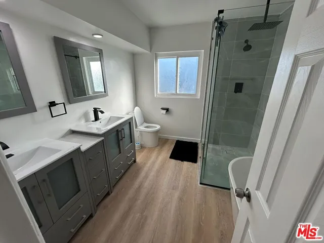 a bathroom with a tub sink and mirror