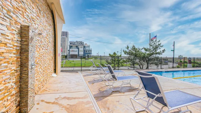 a view of swimming pool with outdoor seating and plants