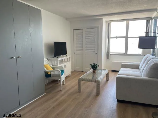 a living room with furniture wooden floor and a flat screen tv