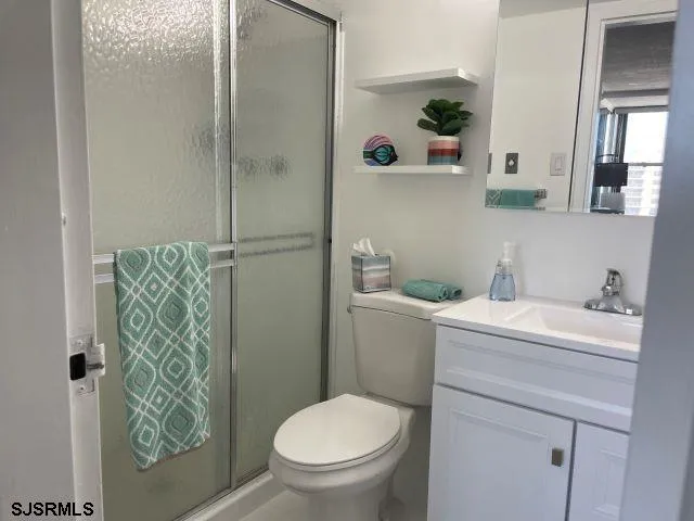 a bathroom with a sink a toilet and shower curtain