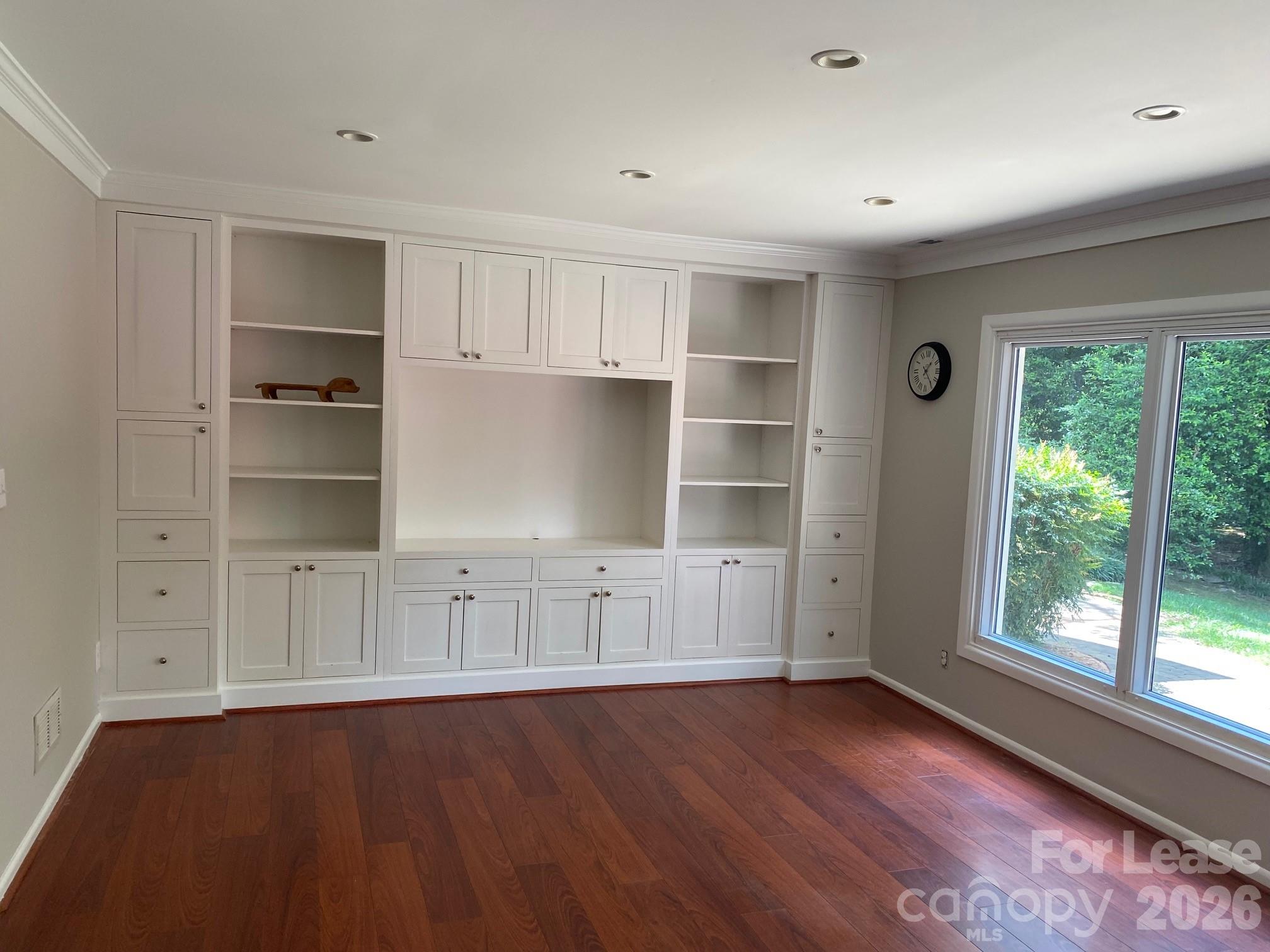 3922 Fellsway Road Charlotte, NC 28209 - Photo 11 of 31 a view of an empty room with a window and wooden floor