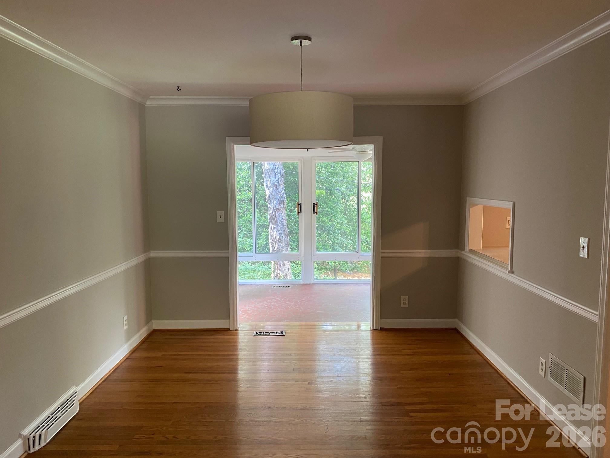 3922 Fellsway Road Charlotte, NC 28209 - Photo 18 of 31 wooden floor in an empty room with a window