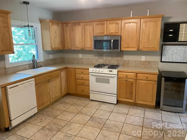 a kitchen with a stove sink and microwave