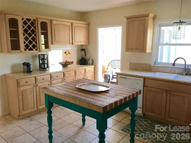a view of a kitchen area with furniture and wooden floor