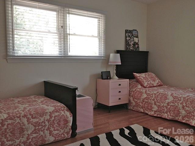 3922 Fellsway Road Charlotte, NC 28209 - Photo 25 of 31 a bedroom with a bed and wooden floor