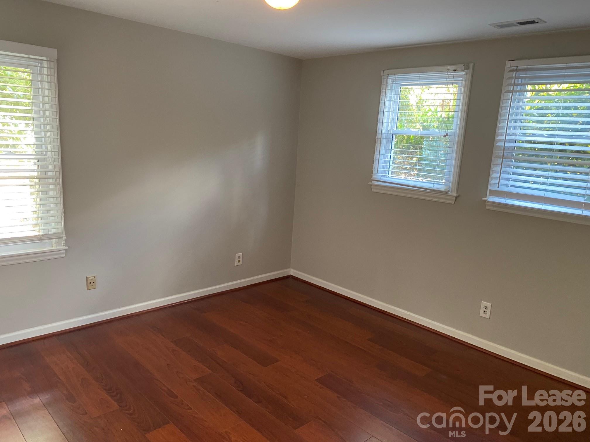 3922 Fellsway Road Charlotte, NC 28209 - Photo 26 of 31 an empty room with wooden floor and windows