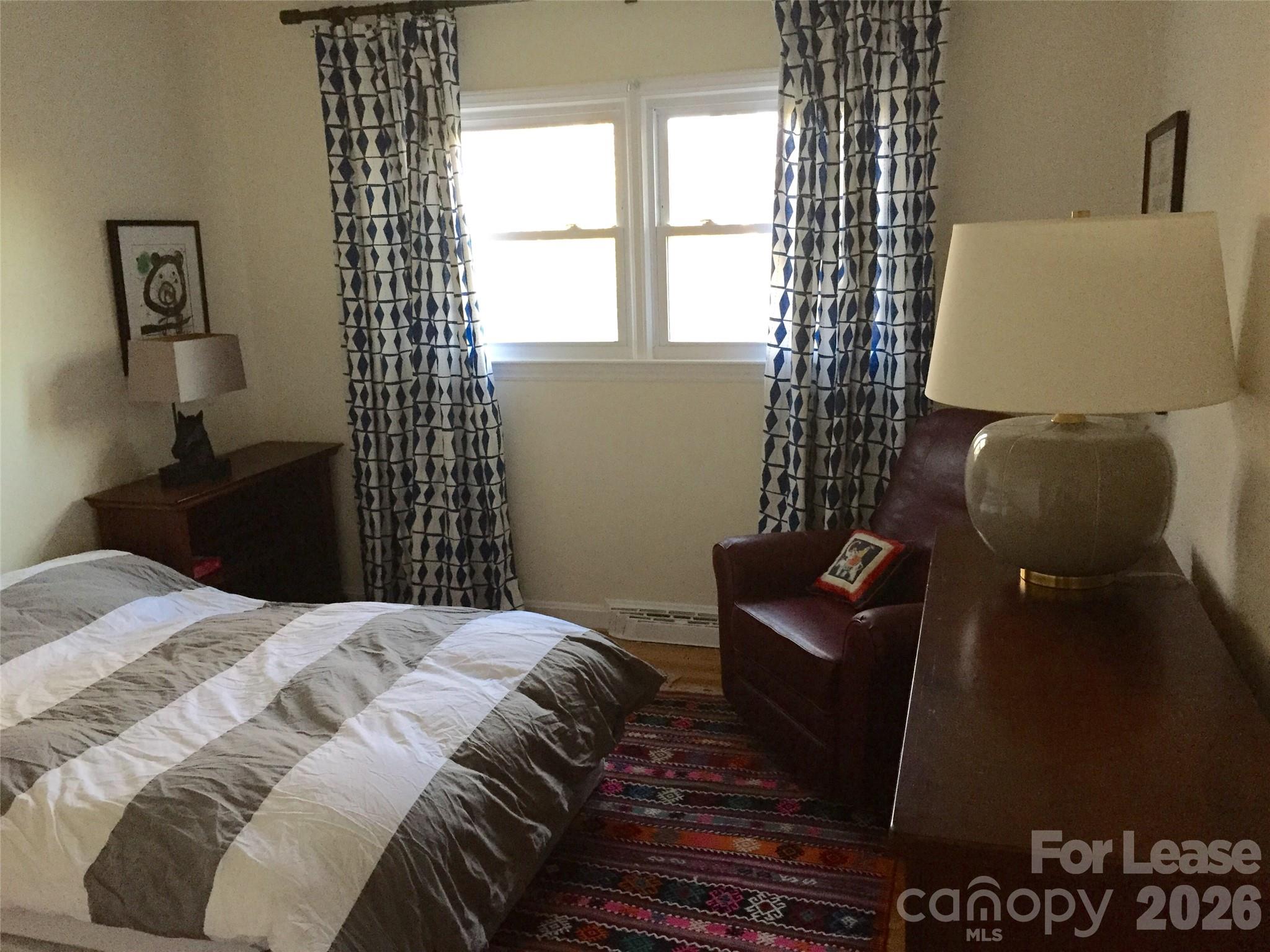 3922 Fellsway Road Charlotte, NC 28209 - Photo 29 of 31 a bedroom with a bed and wooden floor
