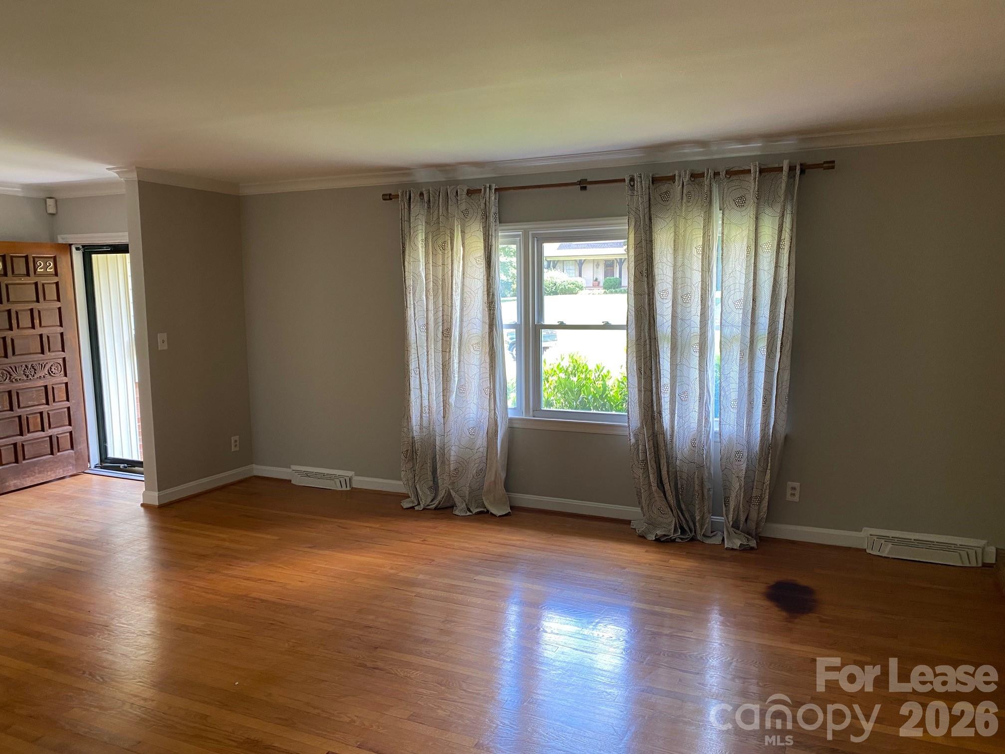 3922 Fellsway Road Charlotte, NC 28209 - Photo 5 of 31 an empty room with wooden floor and windows