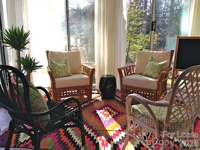 a living room with furniture and a floor to ceiling window