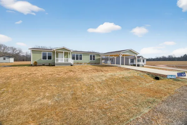 a front view of residential houses with yard and ocean view