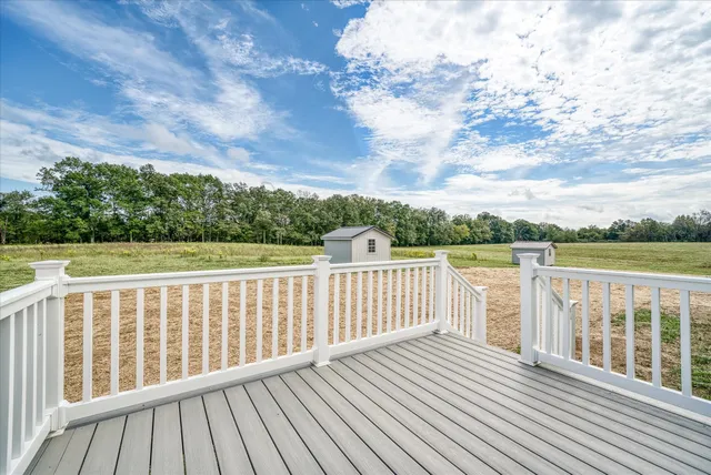 a balcony with wooden floor and fence