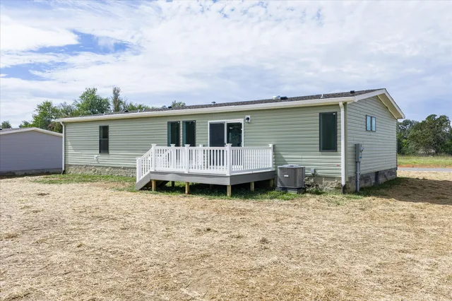 a backyard of a house with yard and barbeque oven