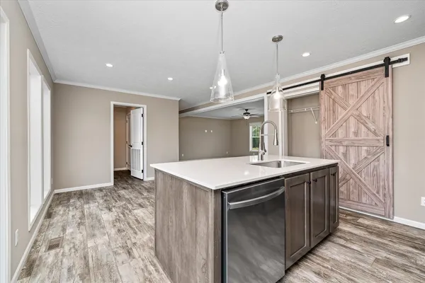 a kitchen with a stove and a wooden floor