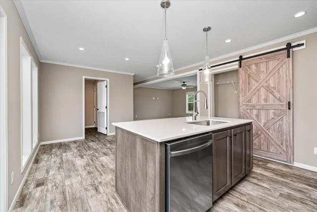 a kitchen with a stove and a wooden floor