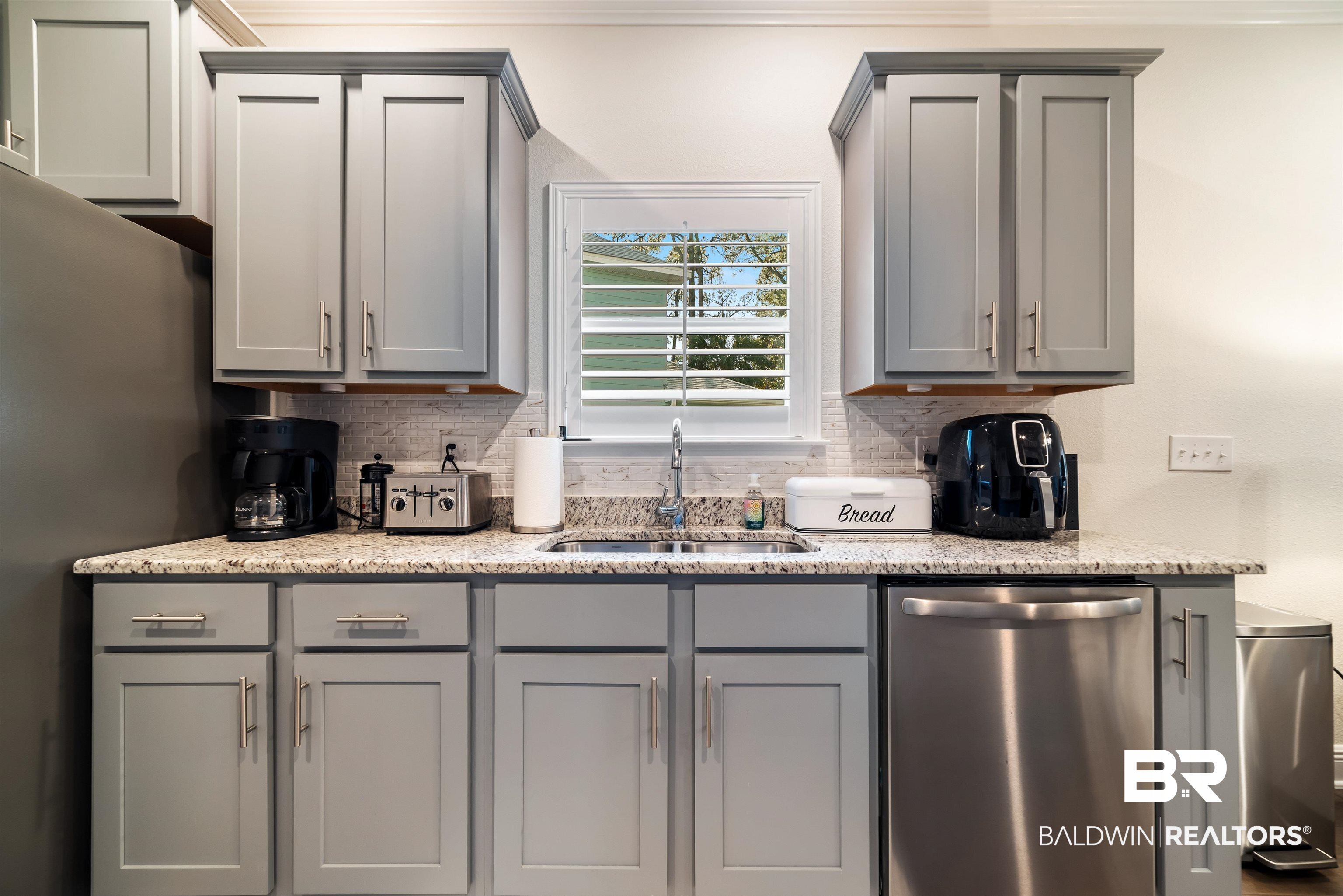 1290 Mako Loop Gulf Shores, AL 36542 - Photo 7 of 50 Kitchen with tasteful backsplash, gray cabinets, a sink, and dishwasher