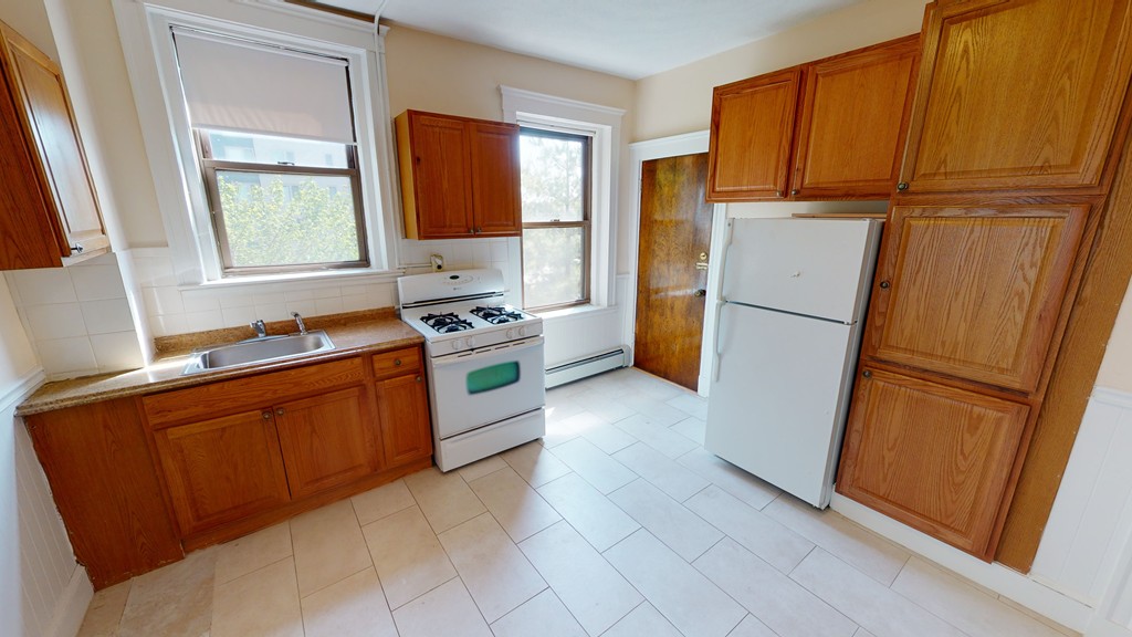 a kitchen with stainless steel appliances a refrigerator stove and cabinets