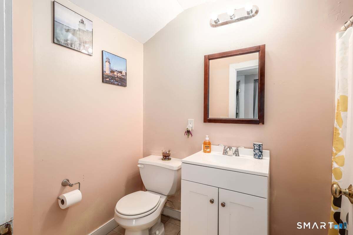 70 Dodgingtown Road Bethel, CT 06801 - Photo 13 of 27 a bathroom with a toilet a sink and mirror
