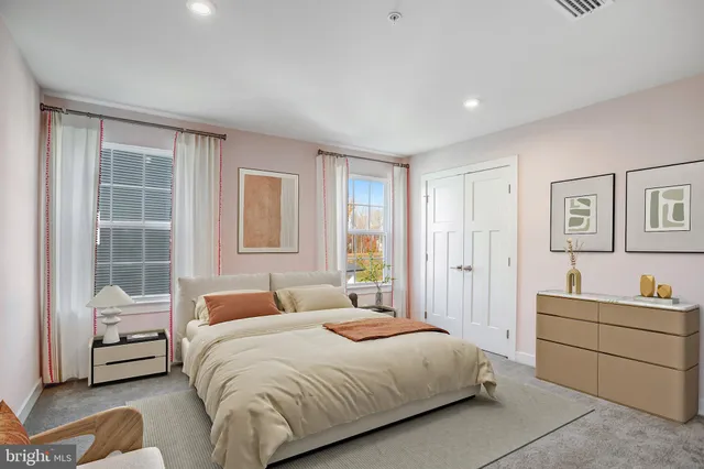 a bedroom with a bed and a couch