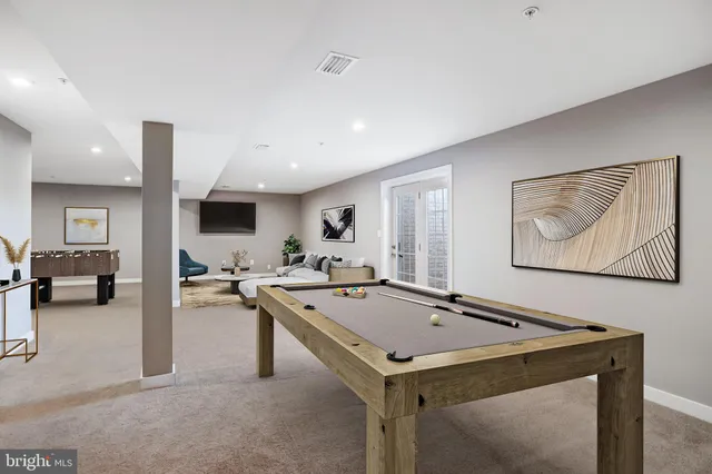 a view of kitchen island sink stove and living room
