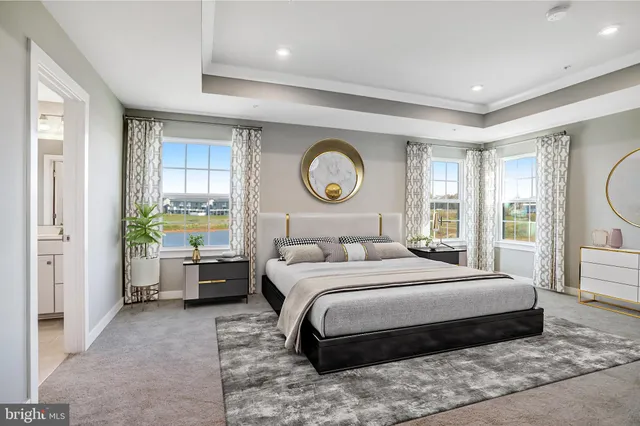 a bedroom with a large bed and a large window