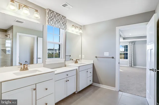 a bathroom with double sink and a mirror