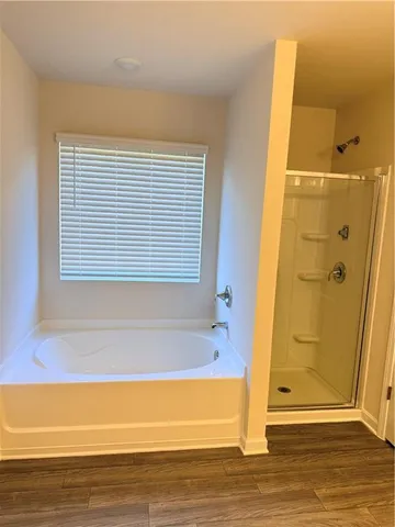 a bathroom with a bathtub and shower