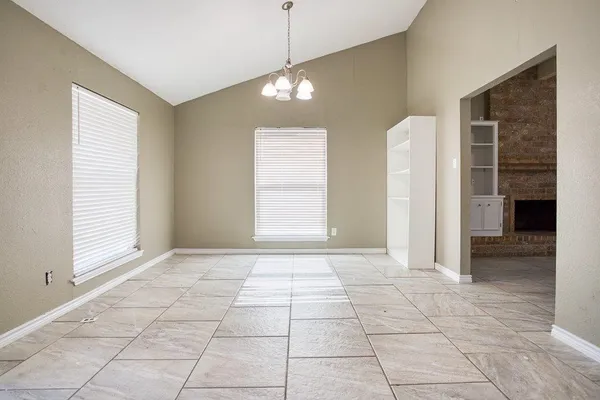 a bathroom with a granite countertop bathtub sink vanity mirror and toilet
