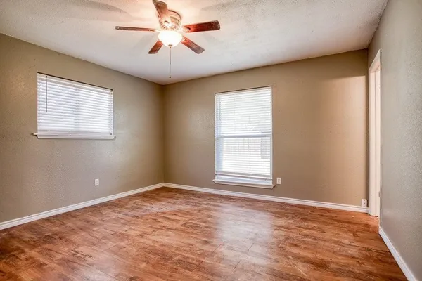 an empty room with closet and wooden floor