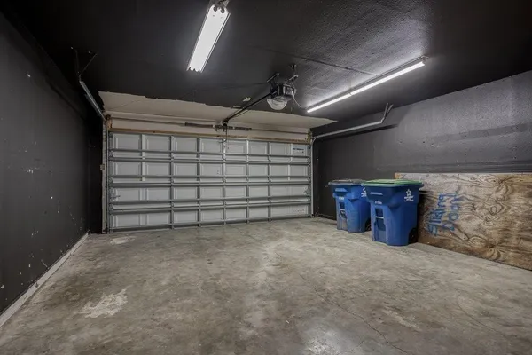 a backyard of a house with wooden floor outdoor seating and yard in the back